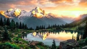 Mountain sunrise nature landscape with golden light on snowy peaks and serene valleys