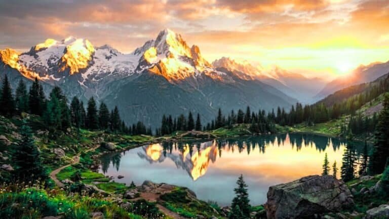 Mountain sunrise nature landscape with golden light on snowy peaks and serene valleys